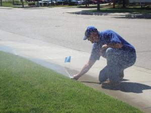 a technician is checking a sprinkler head