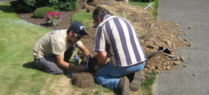 two of our Miami Lakes irrigation repair contractors are fixing a broken line